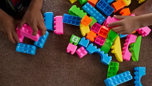 Children play with colourful building blocks in a War Child child-friendly space in Iraq.
