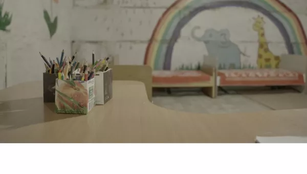 Bedroom with painted walls of animals an rainbow.