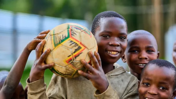 A boy holding a football.