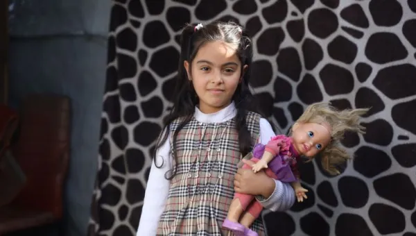 Zina holding a doll