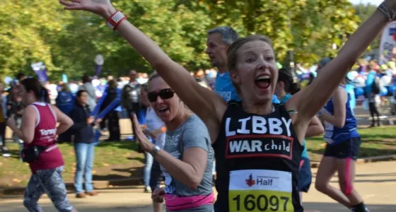 Team War Child runner Libby celebrates whilst running the Royal Parks Half