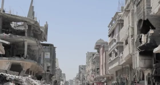 Child running in Gaza in between collapsed buildings. 