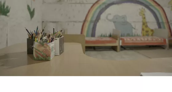 Bedroom with painted walls of animals an rainbow.