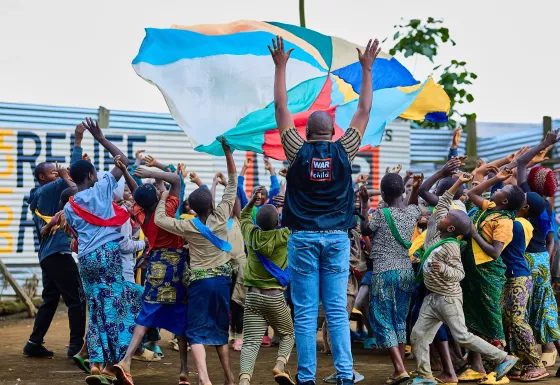 Children and War Child staff playing with a parachute