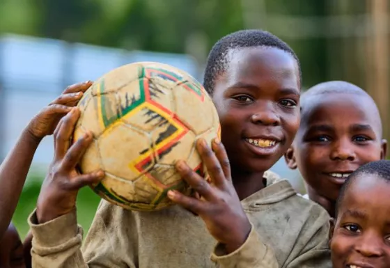A boy holding a football.