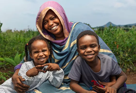 Mother smiling with her son and daughter.