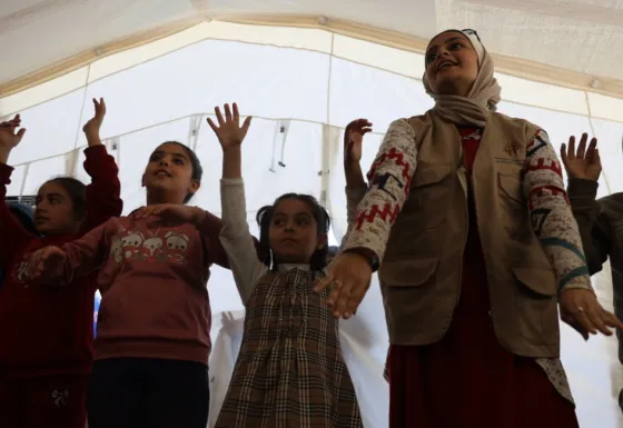 Children taking place in an activity at a refugee camp in Gaza.