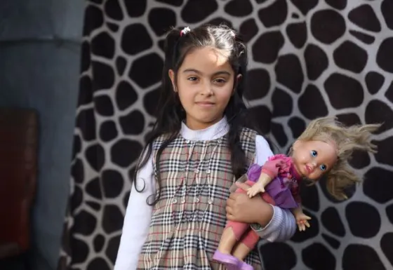 Zina holding a doll
